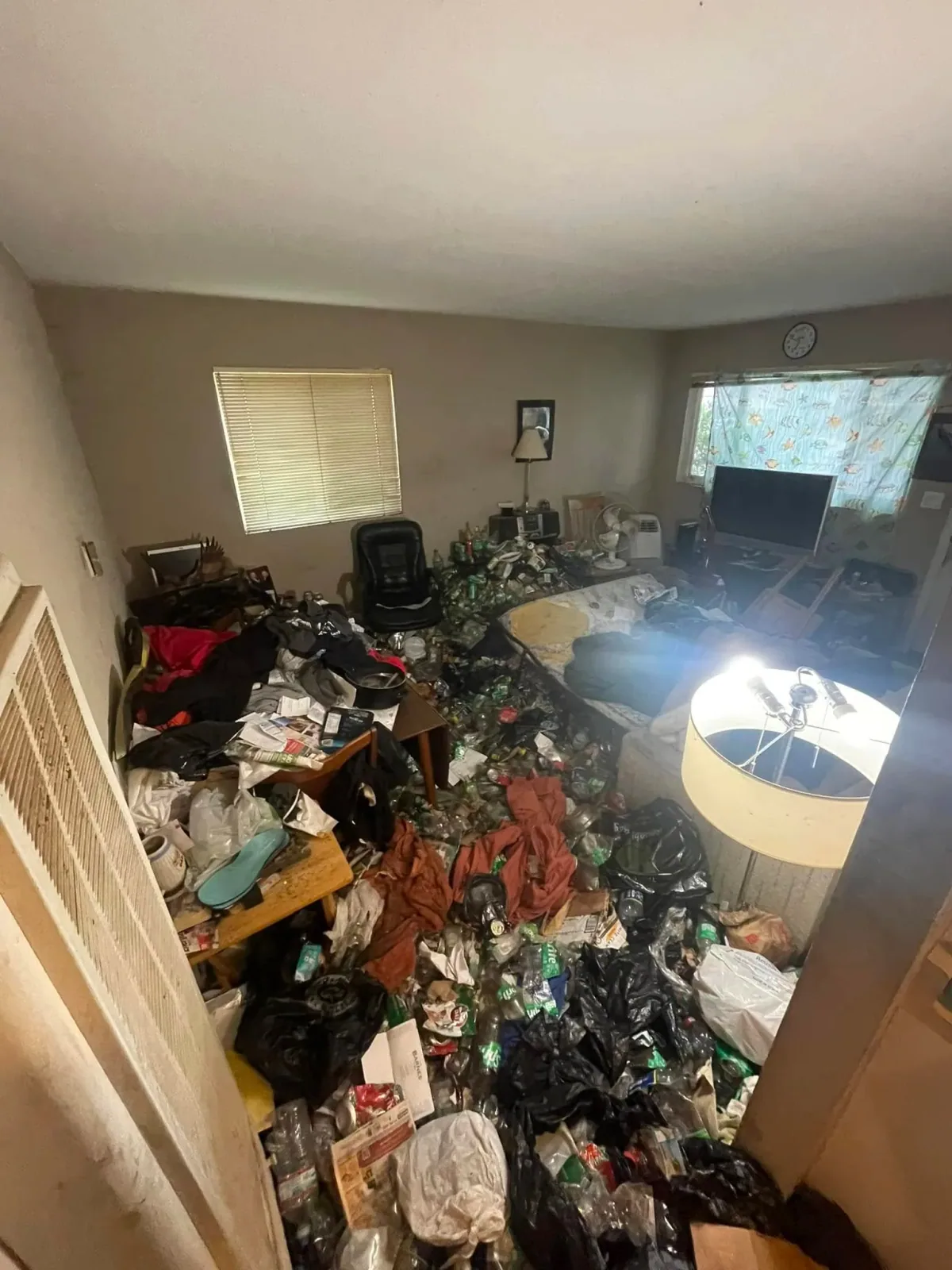 Furniture and accumulated household belongings in a room